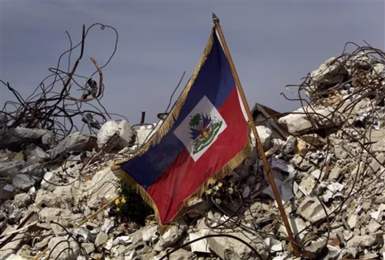 A Haitian flag sits on the rubble of the university of applied languages where 175 students died on Jan. 12 during the earthquake in Port-au-Prince.